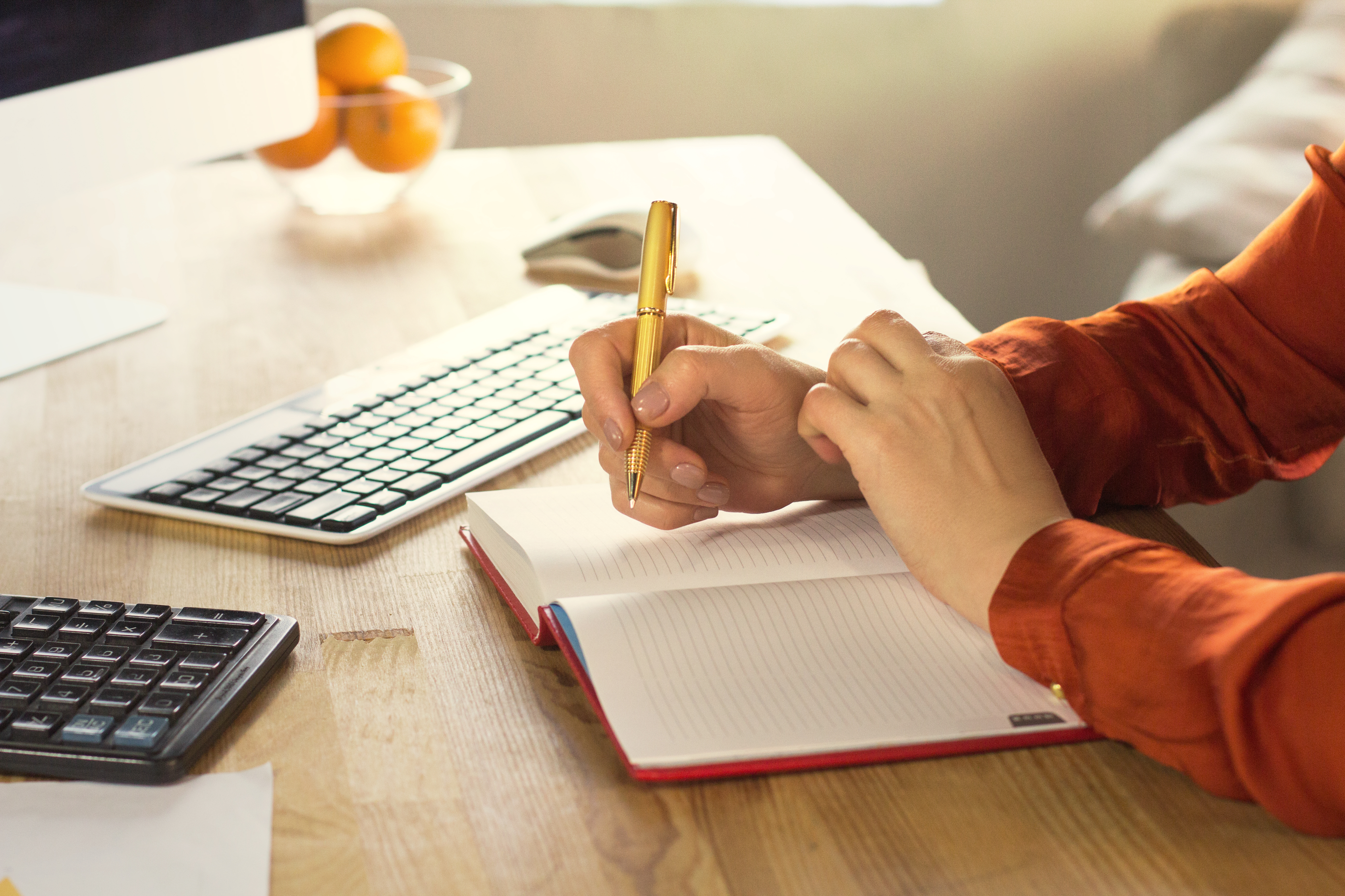 Females hand writing in notebook.jpeg