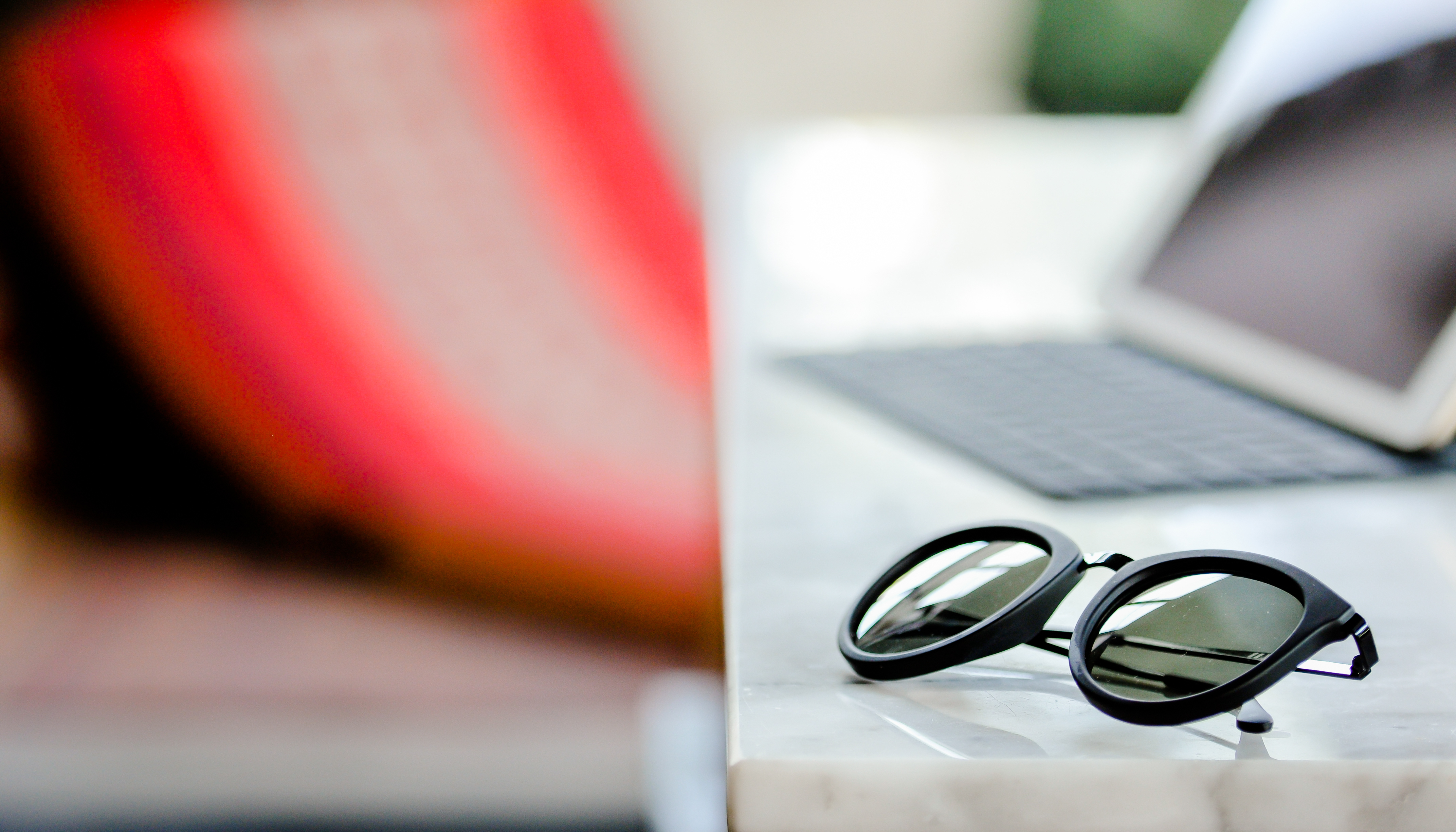 sunglass and notepad on the table, selective focus on the sunglass on holiday.jpeg